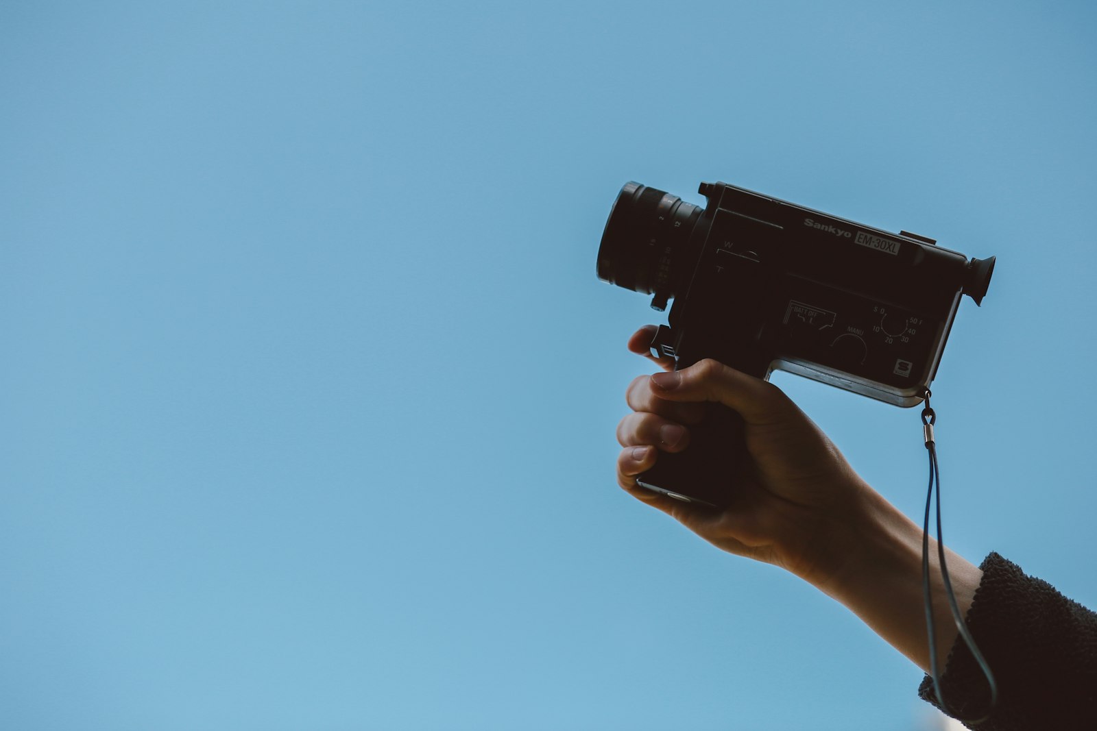 Hand holding a film camera
