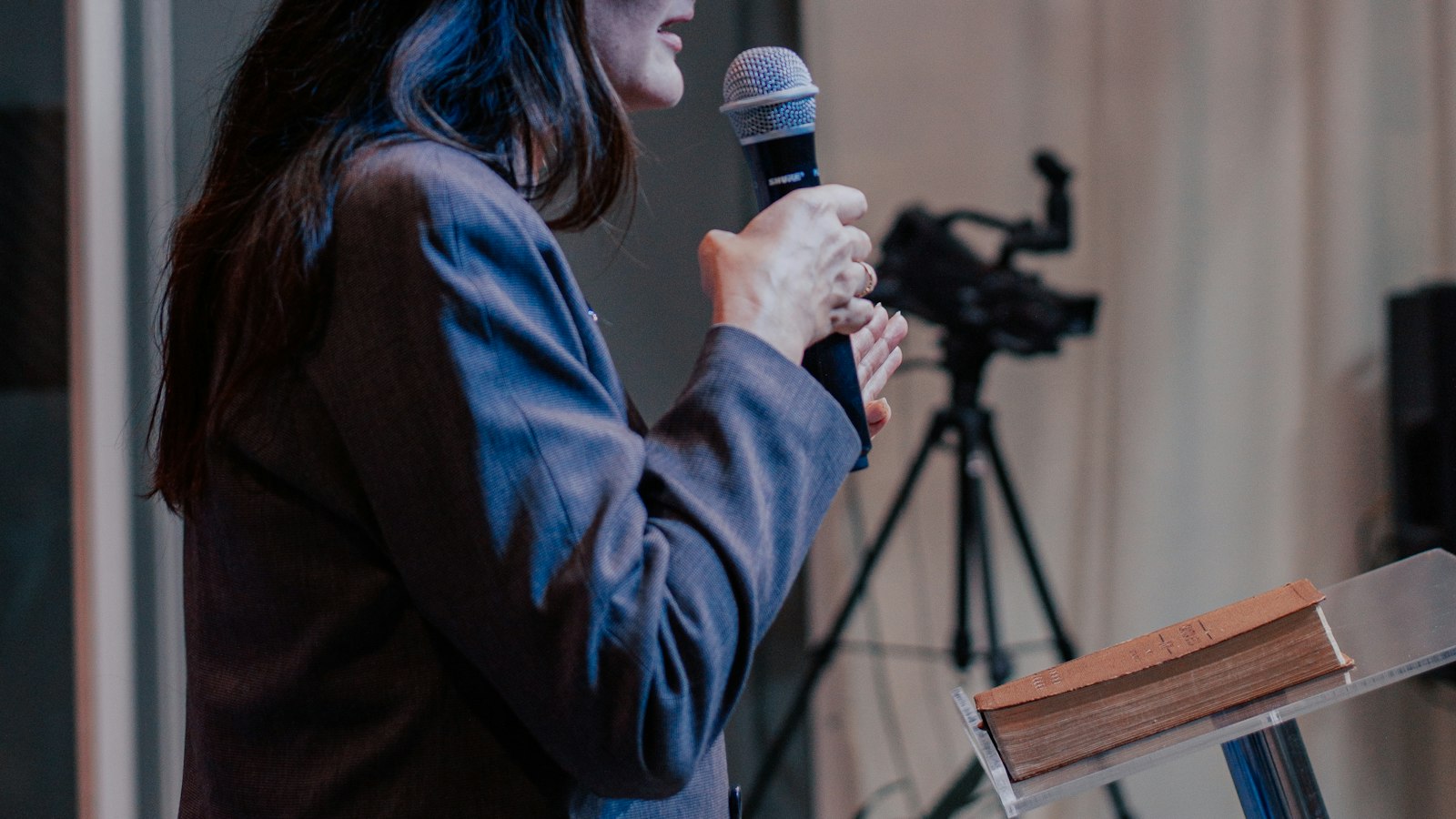 Woman speaking into a microphone